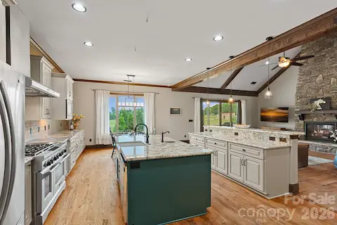 Kitchen and family room with windows opening to horses grazing in pastures.