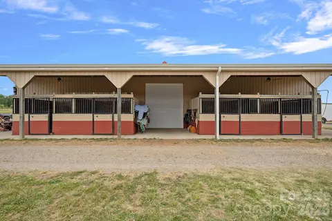 Exterior of automotive workshop has 4 stalls.