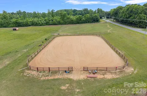 Large riding ring with sand footing.