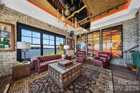 LAKESIDE LOUNGE FEATURING A STRIKING CUSTOM CANOE CEILING LIGHT FIXTURE,  EXPOSED BRICK ACCENTS AND CUSTOM WALL ART
