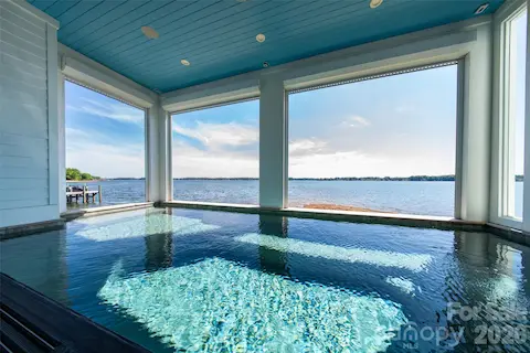 RESORT STYLE LIVING AT ITS FINEST.  BEAUTIFUL PLANK CEILING, MODERN STRUCTURAL PILLARS WITH AUTOMATIC CROCI SHUTTERS FROM CEILING TO POOL TOP CREATING JUST ANOTHER REASON TO STAY AT HOME AND EMBRACE THE PICTURE PERFECT LAKESIDE BACKDROP