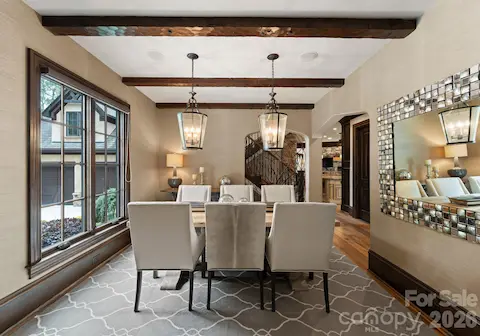 Formal dining room with dual pendant lights and foyer proximity.