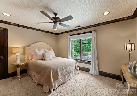 Each Guest Bedroomfeatures TVs, fans, and wallpaper.