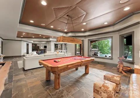 Lower-Level Living Roomis an open lounge space with TVs, billiards, and arcade games.