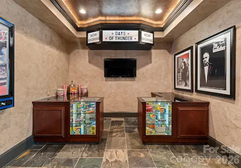 Vintage-style theater room entryway featuring snack cabinets and an icemaker.
