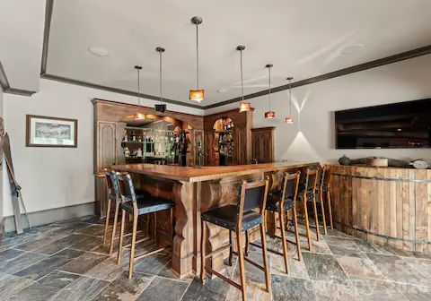 Lower-Level Bar is fully equipped with dual dishwashers, beverage fridge, icemaker, soda dispenser, and extensive storage.
