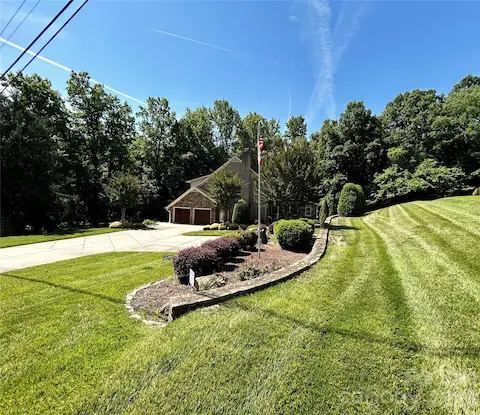 Almost Acre setting with large driveway to side-load Garage
