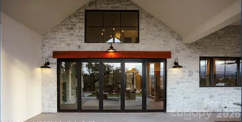 View of Patio Doors Looking from Covered Porch into the Living Room of the Proposed Modern Farmhouse