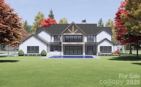 This image features the rear view of the proposed, luxury modern farmhouse, artfully blending rustic charm with sleek, contemporary design. (Pool not included).