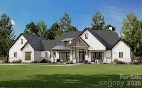 Large windows and clean lines offer a perfect blend of classic charm and contemporary design, all set against a lush green lawn and mature trees for a picturesque country feel.