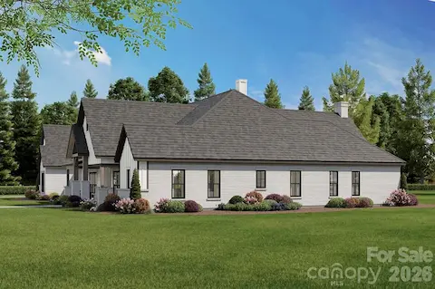 Expansive windows offer abundant natural light, while the landscaped yard and surrounding trees provide privacy and a serene, natural backdrop.