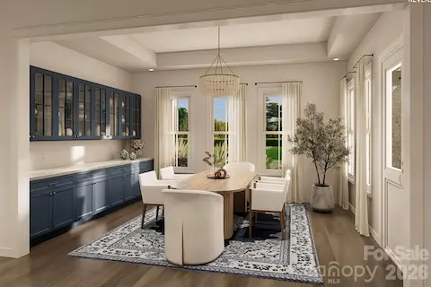 This elegant dining room offers a perfect balance of sophistication and warmth. The space features full-height navy built-in cabinetry with glass-front upper doors.