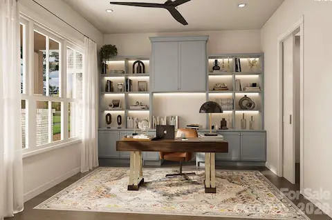 This beautifully designed home office features custom built-ins with soft blue cabinetry, warm accent lighting, and open shelving for stylish storage and display.