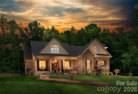 Actual twilight photo of the home before fencing and pool