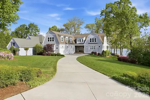 Front exterior showcases a well-maintained lawn, landscaped yard, and inviting covered entry.