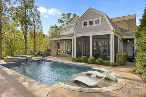 Rear exterior showcases a screened porch, covered patio, and pool area designed for outdoor living and entertaining.