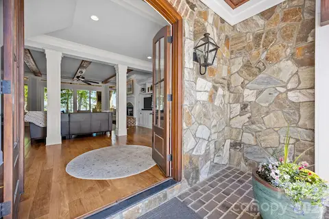 Inviting front entry with stone accents and a welcoming foyer that opens to a light-filled interior.