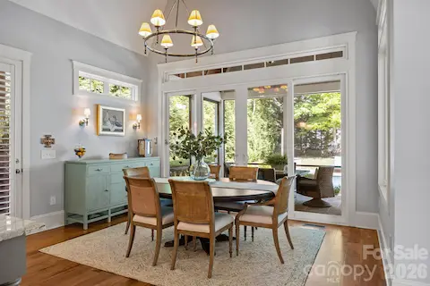Dining area features sliding doors opening to a screened porch.