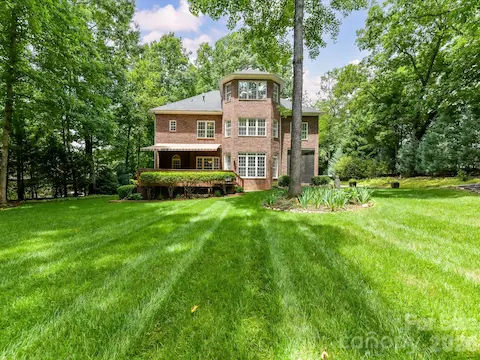 Expansive, park-like backyard offers exceptional privacy, lush landscaping, and a spacious covered deck perfect for relaxing or entertaining outdoors.