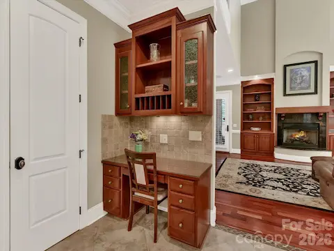 Convenient built-in planning station with custom cabinetry and desk space creates the ideal hub for work, organization, or homework just off the kitchen.