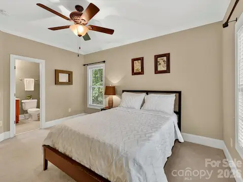 Spacious secondary bedroom features large windows, soft natural light, and a private en-suite bath for added comfort and convenience.