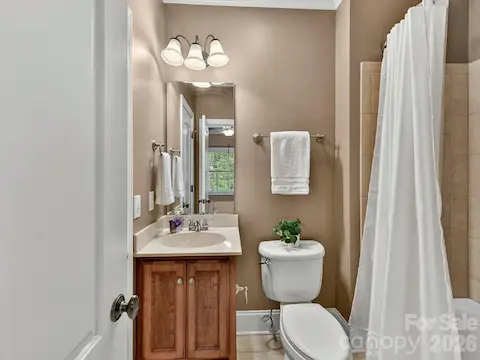 Private en-suite bath offers stylish finishes and convenient comfort, creating an ideal setup for guests or family members.
