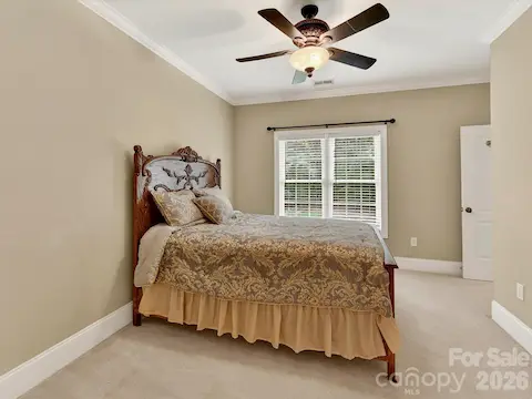 Comfortable secondary bedroom offers generous natural light, neutral finishes, and an inviting layout ideal for family or guests.