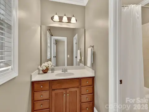 Well-appointed Jack-and-Jill bath features a spacious vanity with ample storage and convenient access for adjoining bedrooms.