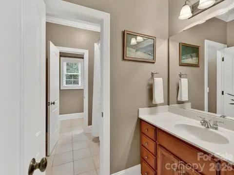 Well-appointed Jack-and-Jill bath features a spacious vanity with ample storage and convenient access for adjoining bedrooms.