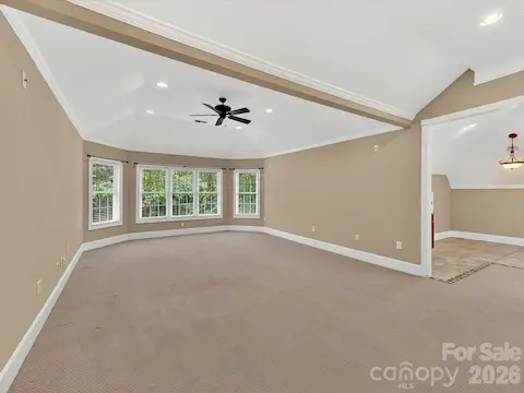 Expansive third-level bonus room offers incredible flexibility with vaulted ceilings, recessed lighting, built-in wet bar, and abundant space for entertaining, recreation, or a home theater.