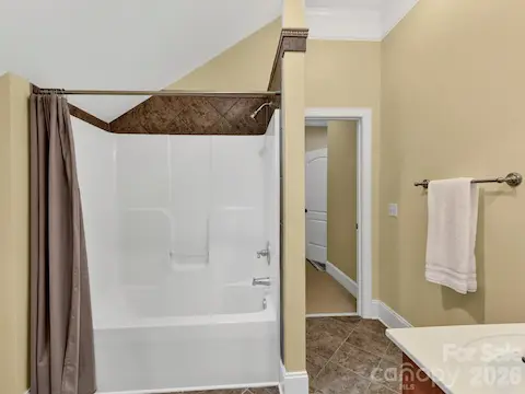 Full bath features a stylish vanity, updated lighting, and convenient access to the spacious third-level bonus area.