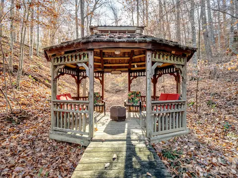 Charming gazebo surrounded by natural landscaping, offering a peaceful retreat.