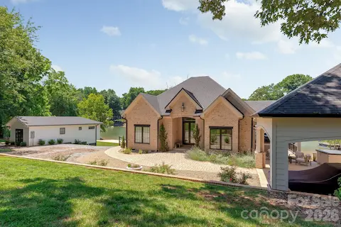 View of front of home with porte-cochere and Main home and guest cottage