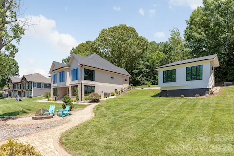 Waterfront View of Firepit and main house and guest cottage