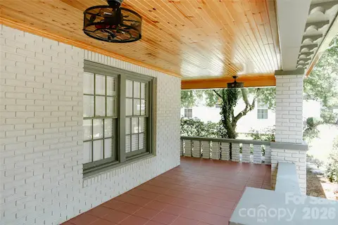 oversized wraparound covered front porch with stylish ceiling fans