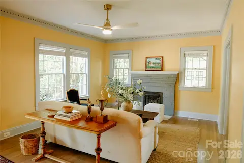 Front living room with historic mantle and unique summer cover and original crown molding
