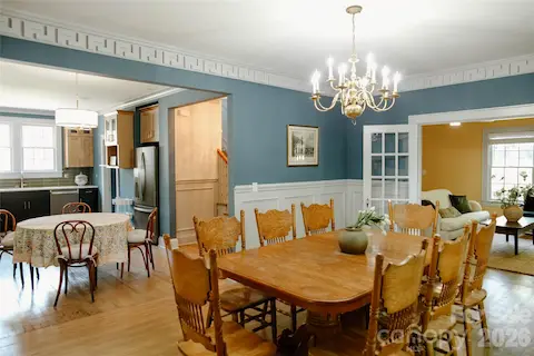 view from formal dining room into eat-in kitchen, and historic french doors into living room