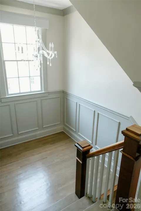 lovely light filled landing with historic chandelier on the staircase between the first and second floors
