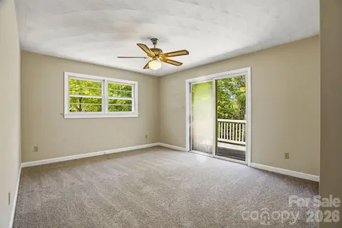 Secondary bedroom opens to the deck, perfect for stepping out to enjoy peaceful surroundings.