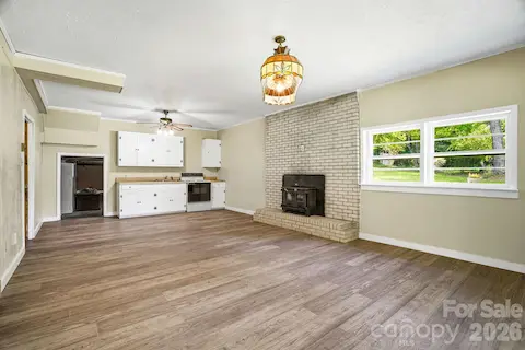 Functional downstairs kitchen with potential to create a second living quarters, providing flexibility and room for renovation or entertaining. High-efficiency insert delivers cozy heat and style.