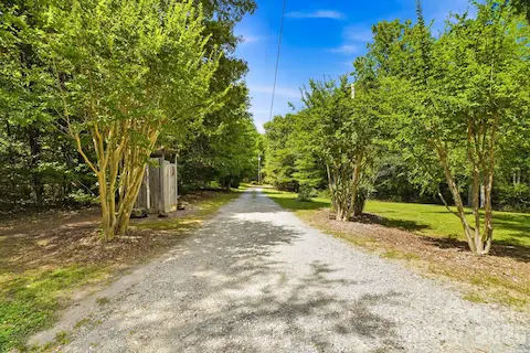 Gravel driveway provides a scenic and private entry to the property.