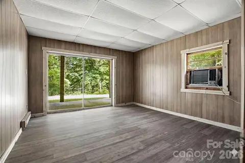 Fourth bedroom downstairs with patio access, offering flexibility for guests, family, or work space.