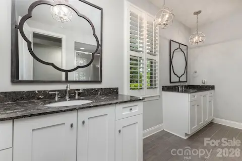 Primary bath with separate vanities; shower; water closet; walk-in closet connected to laundry;