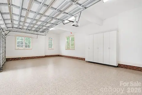 3 car garage w/ epoxy floors and cabinets.