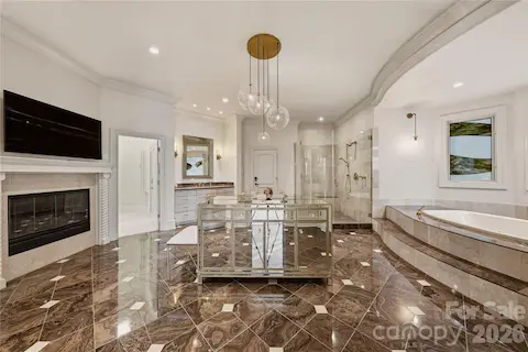 Main-level primary ensuite with two walk-in closets and access to the owner's garage. 