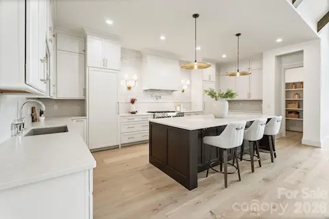 Gourmet kitchen highlighted by quartz counters, spacious island, and huge walk-in pantry