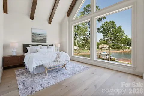 The wall of windows brighten the main level primary bedroom