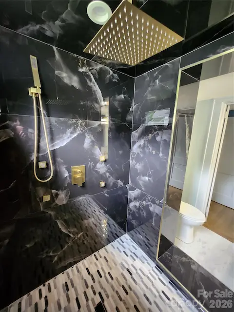 gorgeous multiple faucet shower in downstairs full bath