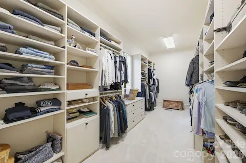 Large walk-in closet w/new carpet, laundry hamper, built-in dresser