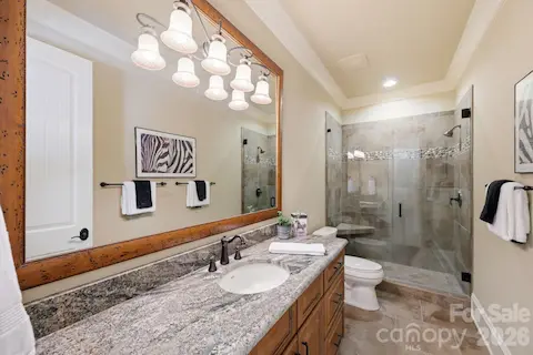 Guest suite 1 with frameless glass, tile and pebble shower